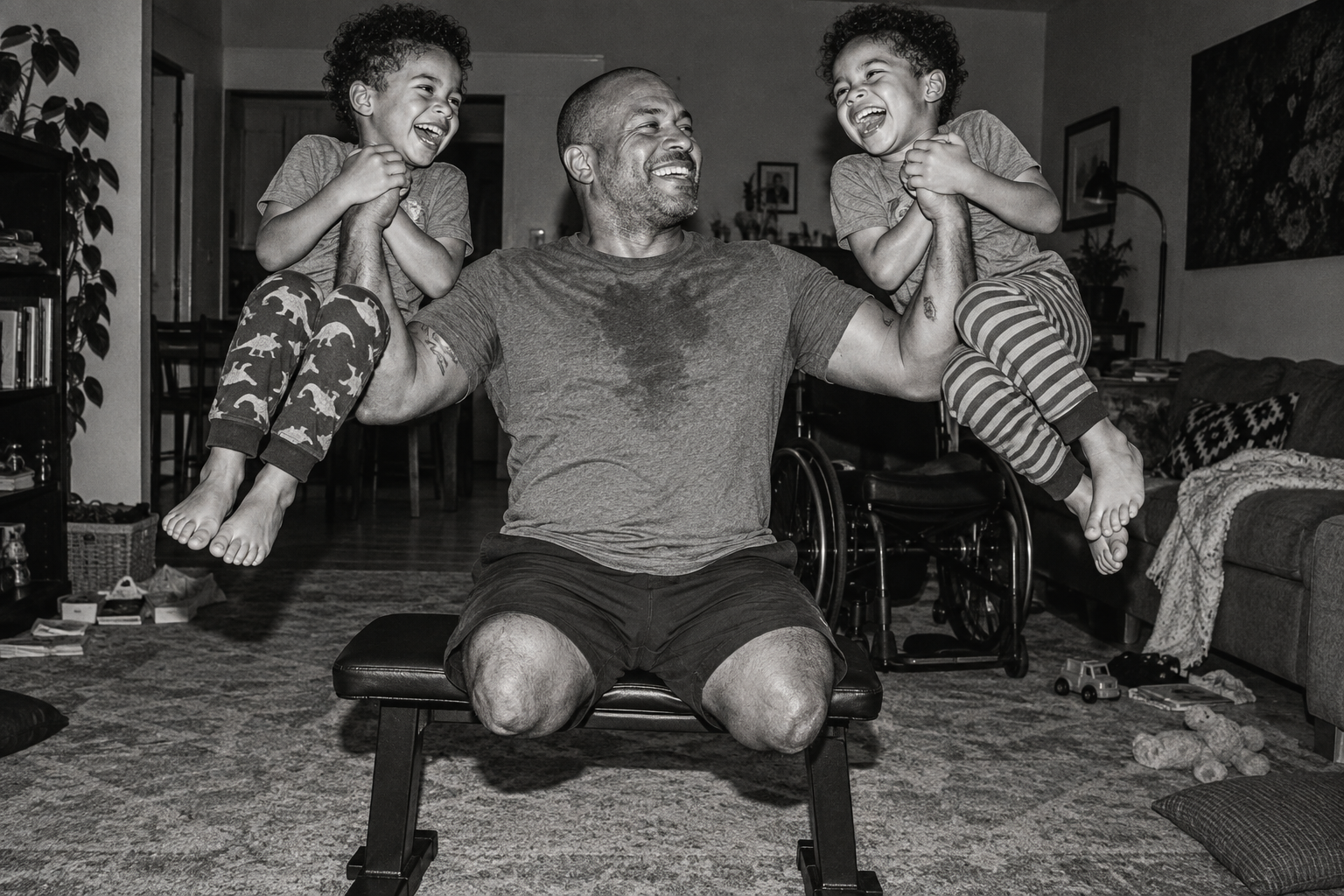 An adaptive-athlete father safely plays a lifting game with his twin boys, his wheelchair behind him